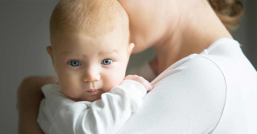 Baby being held by mother