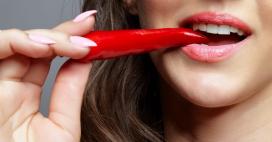 woman eating red hot chili pepper